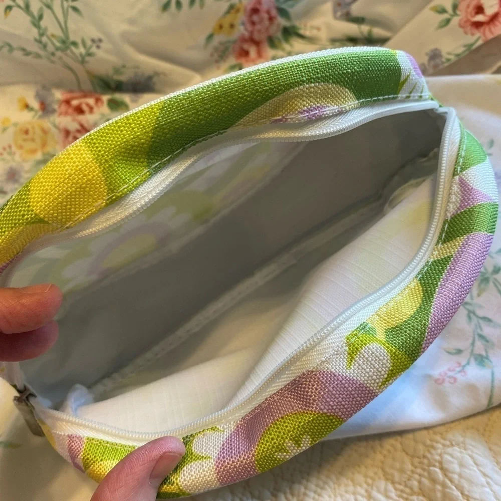 Clinique NWOT cosmetic bag. Green, yellow, purple and white. White inside